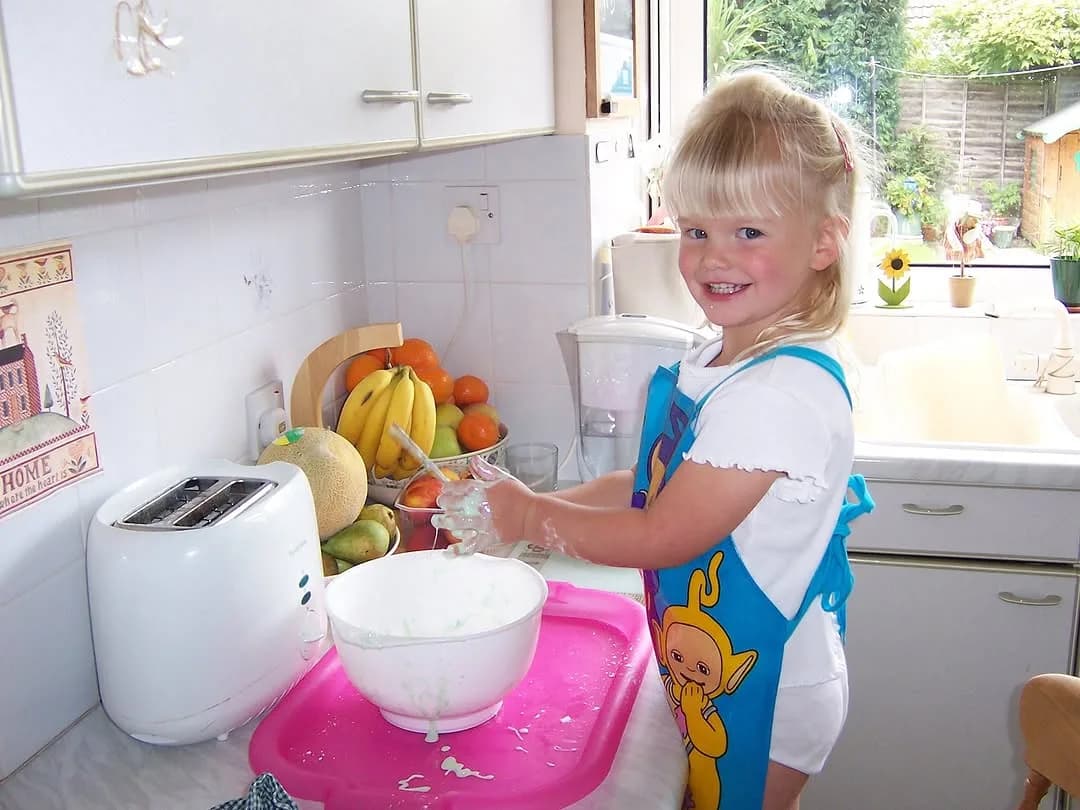 Young Beth baking in Mum's kitchen as a child
